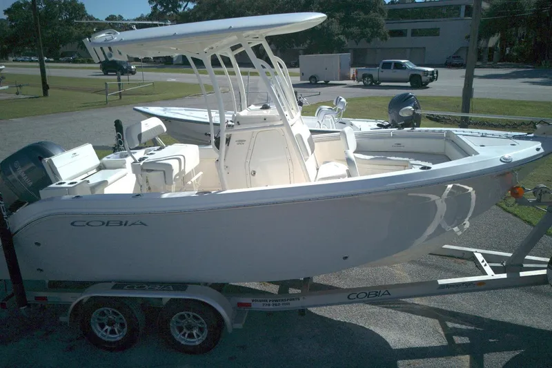Slide: The Image of 2022 Cobia 201 Center Console boat on trailer, side view in outdoor setting. - 13