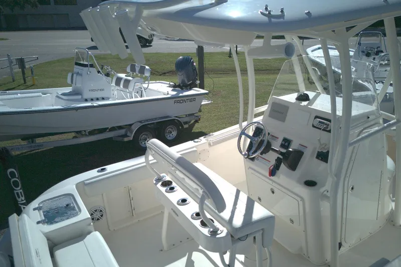 Slide: The Image of 2022 Cobia 201 Center Console boat interior with steering console and seating. - 5