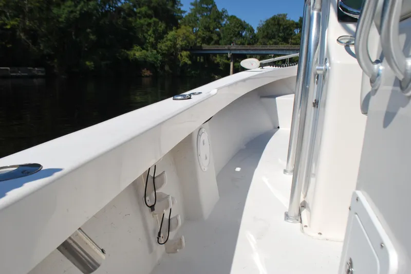 Slide: The Image of 2021 May-Craft 23 Cape Classic boat deck with railing, cruising on a sunny day. - 10