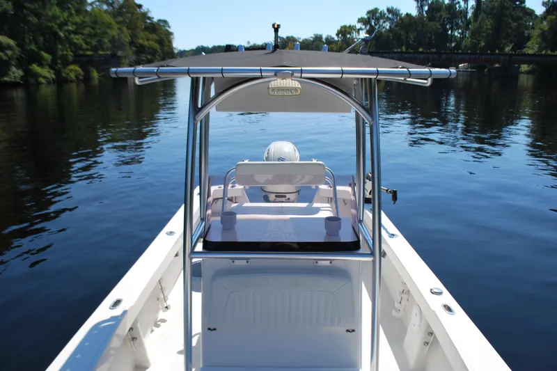 Slide: The Image of 2021 May-Craft 23 Cape Classic boat on calm water, featuring a center console. - 4