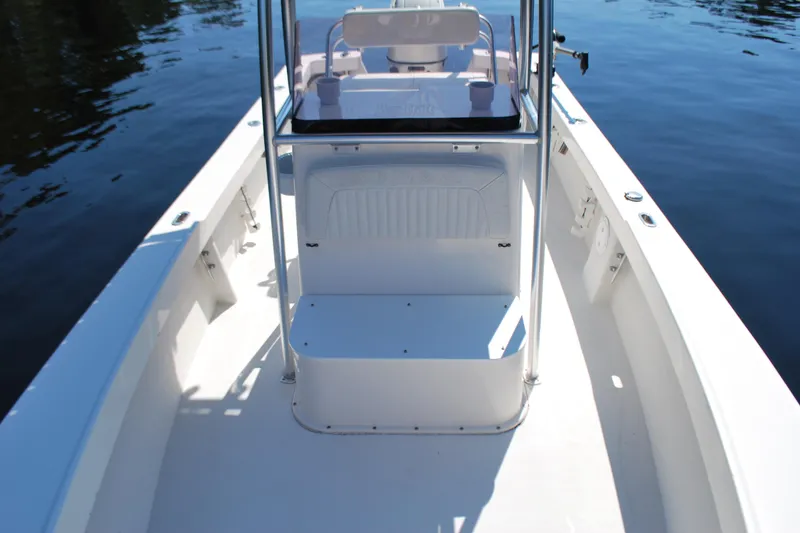 Slide: The Image of 2021 May-Craft 23 Cape Classic boat interior with seating and console on calm water. - 5