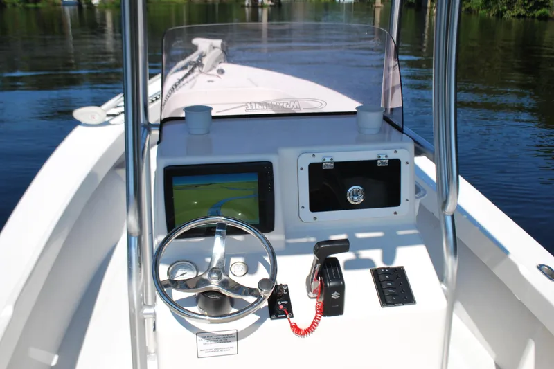 Slide: The Image of 2021 May-Craft 23 Cape Classic boat dashboard with steering wheel and navigation system. - 6