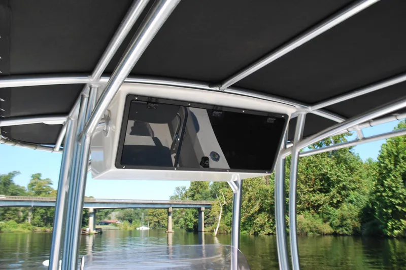 Slide: The Image of 2021 May-Craft 23 Cape Classic boat with T-top, cruising on a scenic river. - 7