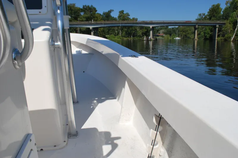Slide: The Image of 2021 May-Craft 23 Cape Classic boat on a calm river near a bridge. - 9