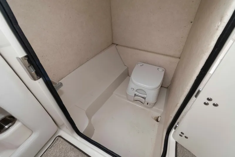 Slide: The Image of Interior of 2010 Sea Ray 240 Sundeck showing compact marine toilet. - 11