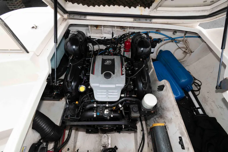 Slide: The Image of Engine compartment of a 2010 Sea Ray 240 Sundeck boat, showcasing the motor and components. - 12