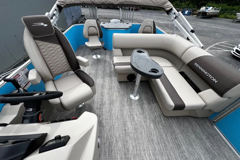 Slide: The Image of 2026 Bennington S22 pontoon boat interior with plush seating and modern helm. - 11