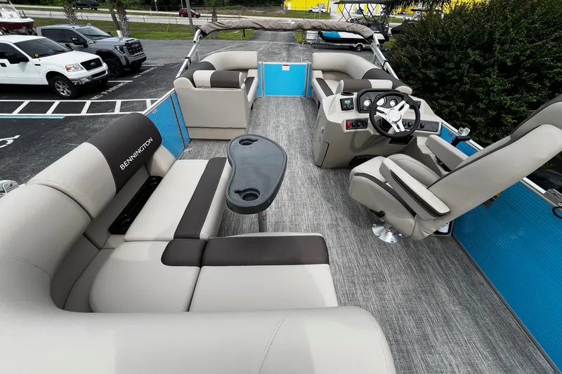 Slide: The Image of 2026 Bennington S22 pontoon boat interior with plush seating and modern helm. - 12
