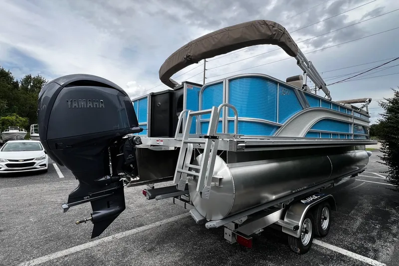 Slide: The Image of 2026 Bennington S22 pontoon boat with Yamaha outboard motor on trailer. - 7
