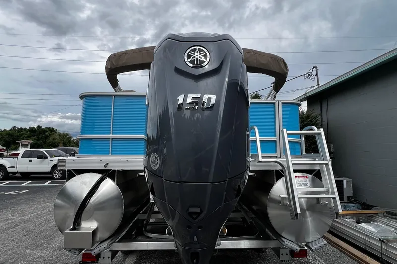 Slide: The Image of 2026 Bennington S22 pontoon boat with powerful 150 engine, parked outdoors. - 8