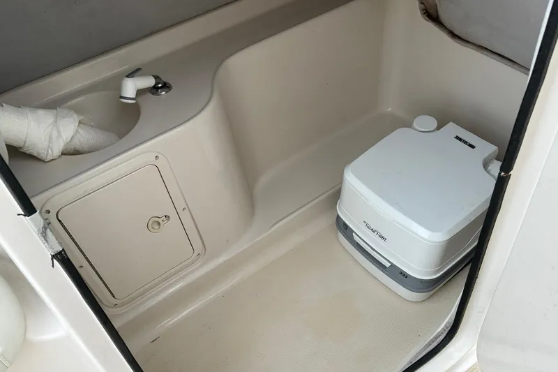 Slide: The Image of Compact bathroom in 2003 Hurricane 234 SD boat with sink and portable toilet. - 10