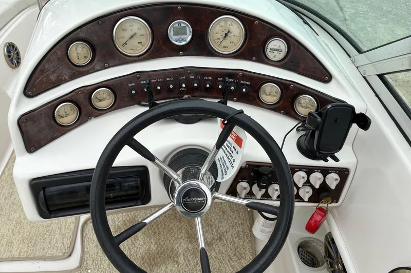 Slide: The Image of Steering console of a 2003 Hurricane 234 SD boat with gauges and controls. - 4