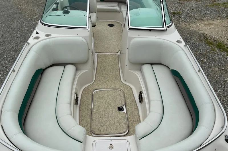 Slide: The Image of 2003 Hurricane 234 SD boat interior with white seating and green accents. - 6