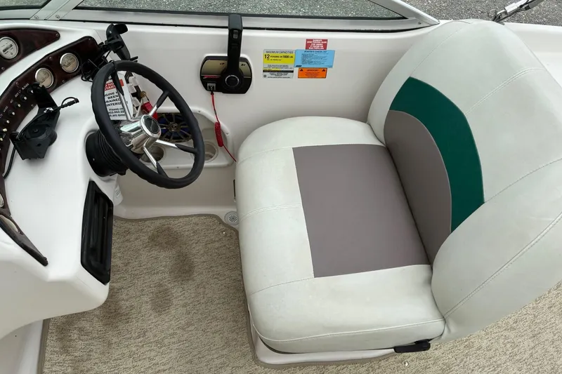 Slide: The Image of Interior of a 2003 Hurricane 234 SD boat with steering wheel and seat. - 8