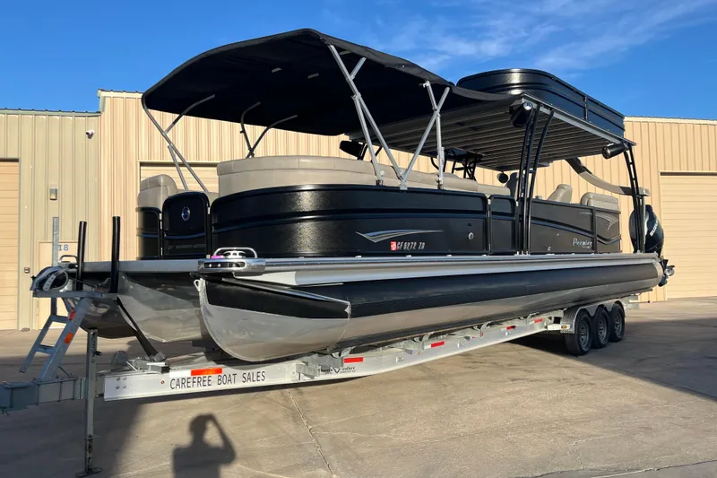 The Image of 2023 Premier 310 Boundary Waters Revolution Top Deck pontoon boat on trailer. - 0