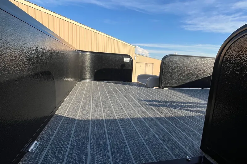 Slide: The Image of 2023 Premier 310 Boundary Waters Revolution Top Deck with textured flooring and sleek design. - 17