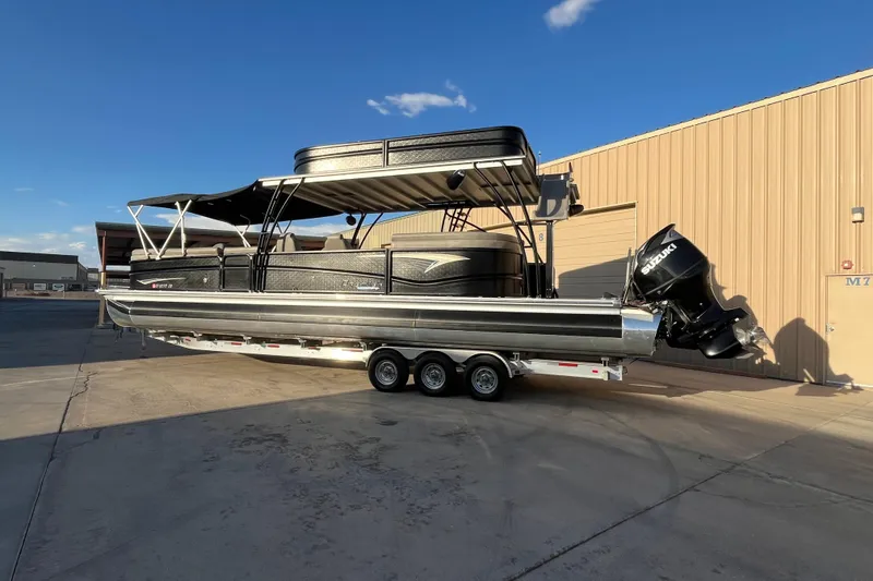 Slide: The Image of 2023 Premier 310 Boundary Waters Revolution Top Deck pontoon boat with Suzuki outboard motor. - 2