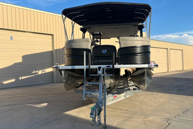 Slide: The Image of 2023 Premier 310 Boundary Waters Revolution Top Deck pontoon boat on trailer. - 20