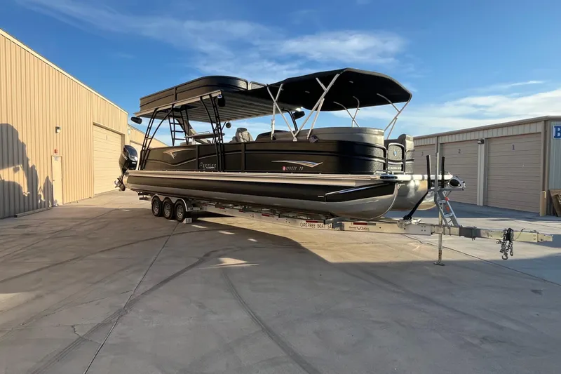 Slide: The Image of 2023 Premier 310 Boundary Waters Revolution Top Deck pontoon boat on trailer. - 4