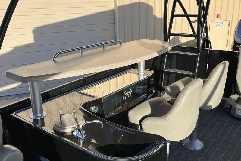 Slide: The Image of 2023 Premier 310 Boundary Waters Revolution Top Deck with seating and bar area. - 7