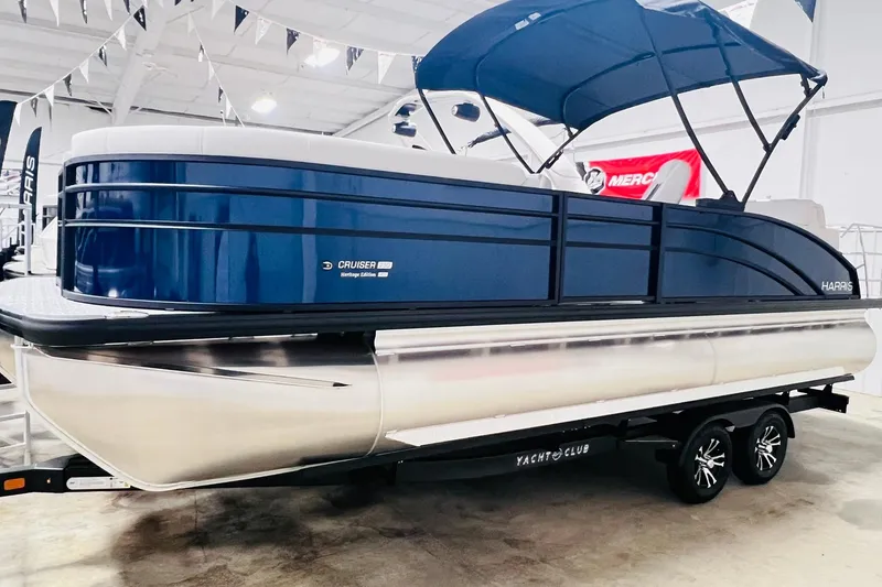 Slide: The Image of 2025 Harris Cruiser 230 Heritage Edition pontoon boat in showroom display. - 1