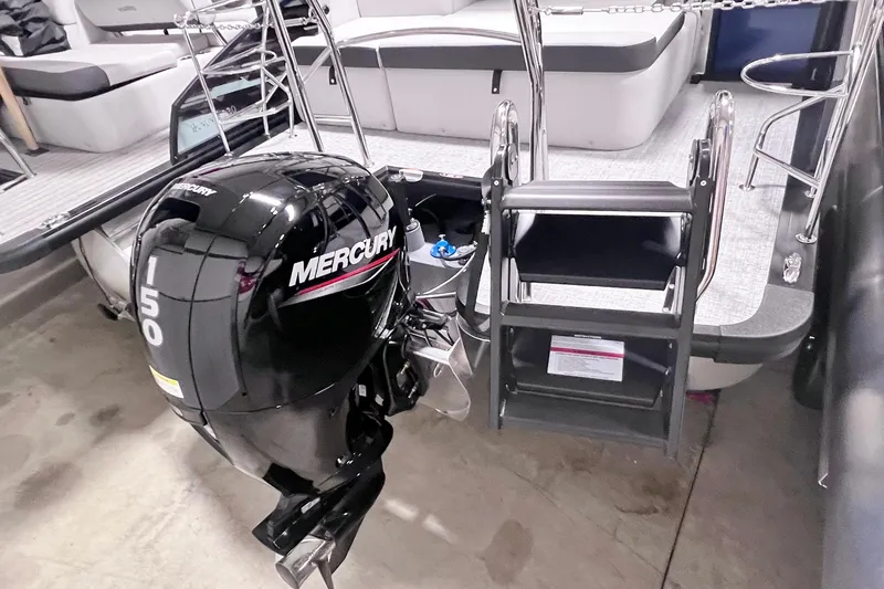 Slide: The Image of 2025 Harris Cruiser 230 Heritage Edition with Mercury 150 outboard motor and swim ladder. - 19