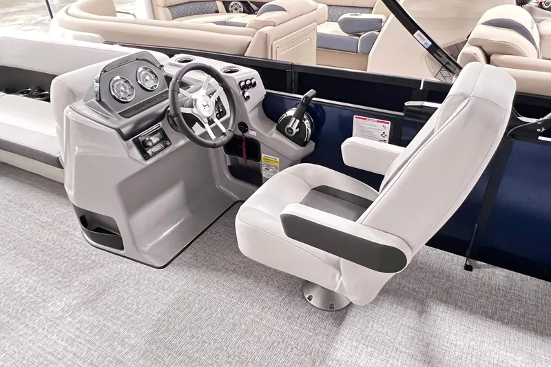 Slide: The Image of 2025 Harris Cruiser 230 Heritage Edition boat interior with modern helm and captain's chair. - 7