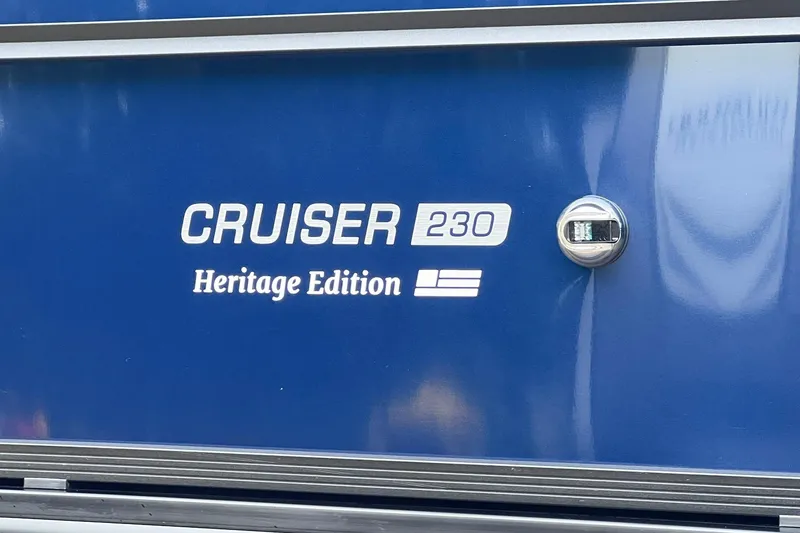 Slide: The Image of 2025 Harris Cruiser 230 Heritage Edition logo on blue surface. - 24