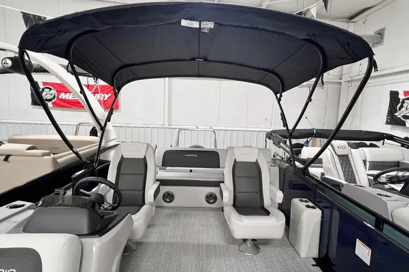 Slide: The Image of 2025 Harris Cruiser 230 Heritage Edition pontoon boat interior with canopy and seating. - 3