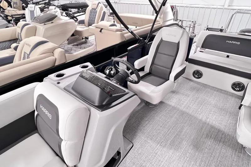 Slide: The Image of 2025 Harris Cruiser 230 Heritage Edition boat interior with modern seating and steering console. - 5