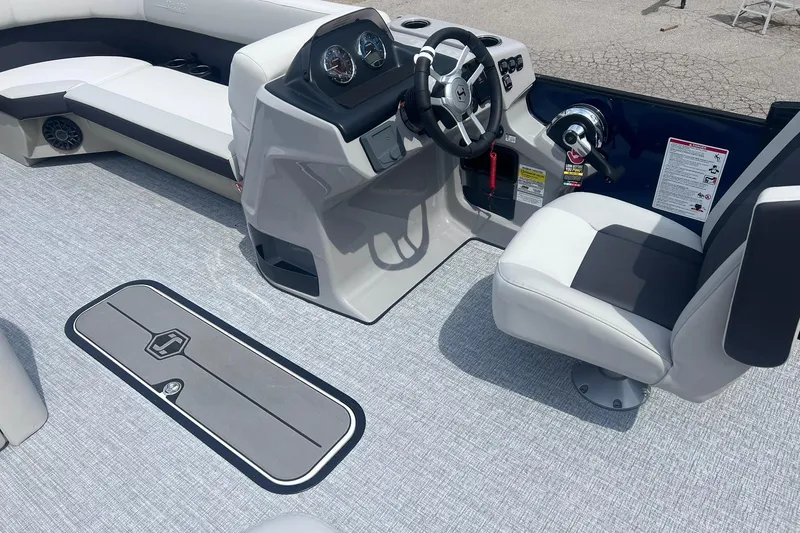 Slide: The Image of 2026 Harris Cruiser 230 boat interior with steering console and seating. - 6
