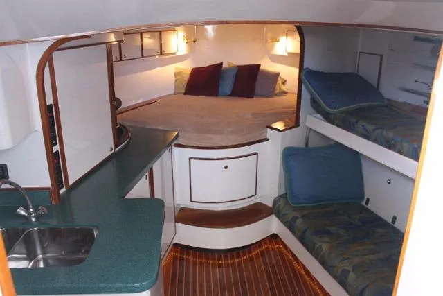 Slide: The Image of Interior of 2005 Custom DeSanti Carolina Express boat with cozy sleeping area and kitchenette. - 14