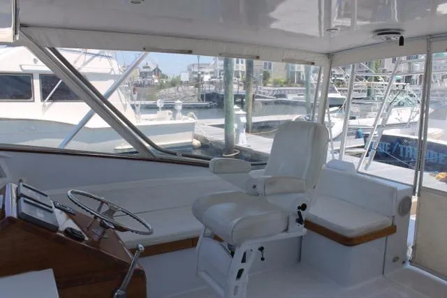 Slide: The Image of Interior of 2005 Custom DeSanti Carolina Express boat with helm and seating area. - 19