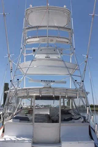Slide: The Image of 2005 Custom DeSanti Carolina Express boat with tower, docked under clear blue sky. - 22