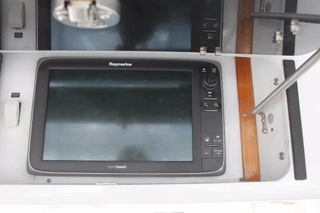 Slide: The Image of Raymarine display on 2005 Custom DeSanti Carolina Express boat dashboard. - 31