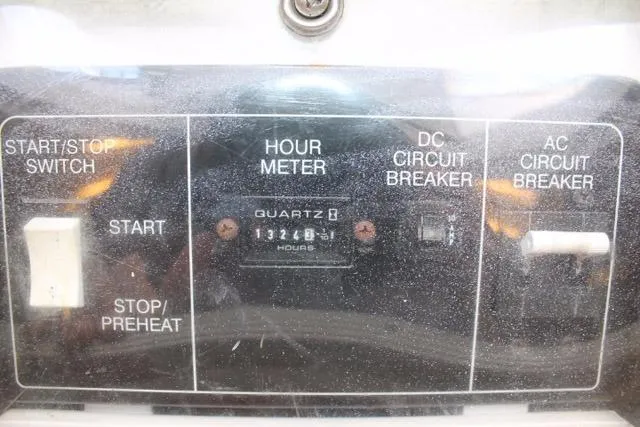Slide: The Image of Control panel of 2005 DeSanti Carolina Express with hour meter and circuit breakers. - 37