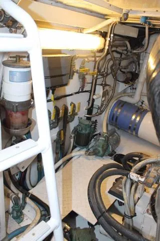 Slide: The Image of Engine room of 2005 Custom DeSanti Carolina Express boat with visible machinery and pipes. - 38