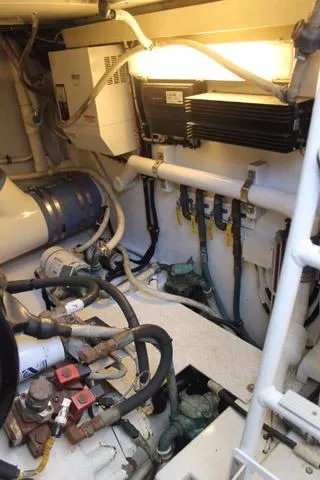 Slide: The Image of Engine room of 2005 Custom DeSanti Carolina Express boat, showcasing mechanical components. - 39
