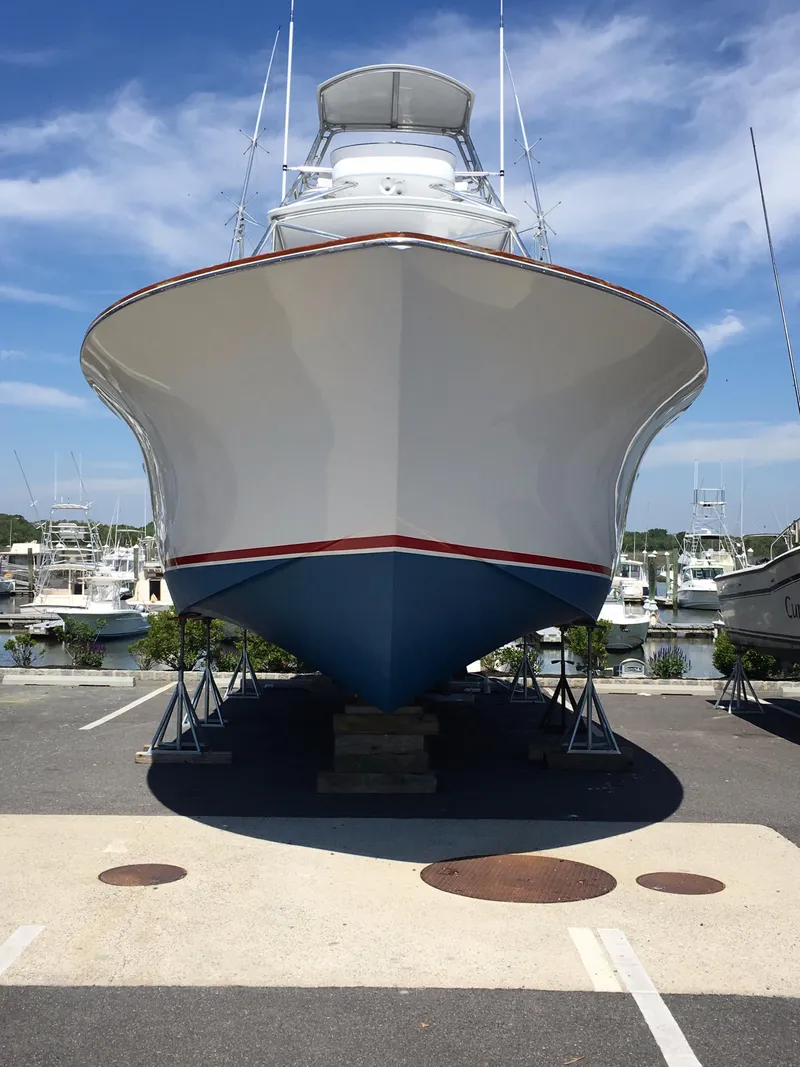 Slide: The Image of Front view of 2005 Custom DeSanti Carolina Express boat on stands, clear sky background. - 48