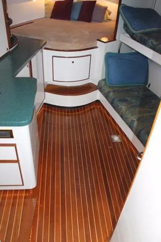 Slide: The Image of 2005 Custom DeSanti Carolina Express cabin with wood flooring and cozy seating. - 5
