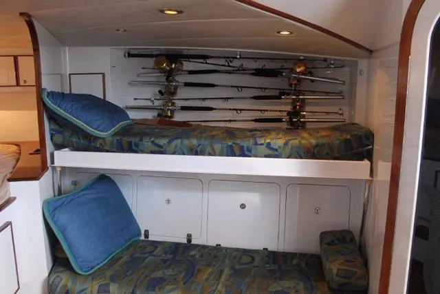 Slide: The Image of Bunk beds with fishing rods in 2005 Custom DeSanti Carolina Express cabin. - 6