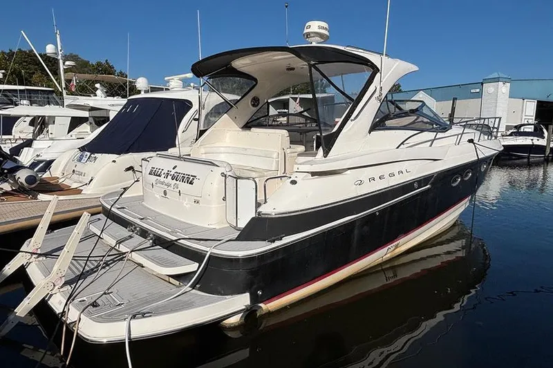 The Image of 2005 Regal Commodore 4260 yacht docked at marina under clear blue sky. - 0