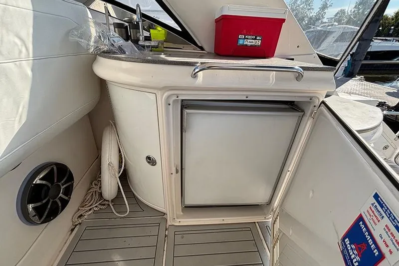 Slide: The Image of 2005 Regal Commodore 4260 boat interior with sink, cooler, and storage. - 10