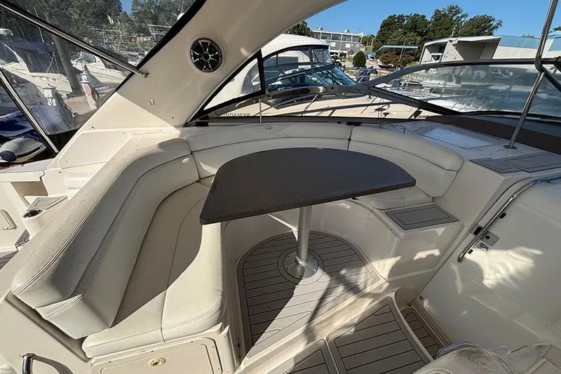 Slide: The Image of 2005 Regal Commodore 4260 yacht interior with curved seating and table. - 11