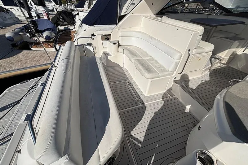 Slide: The Image of 2005 Regal Commodore 4260 yacht interior with white seating and deck view. - 13