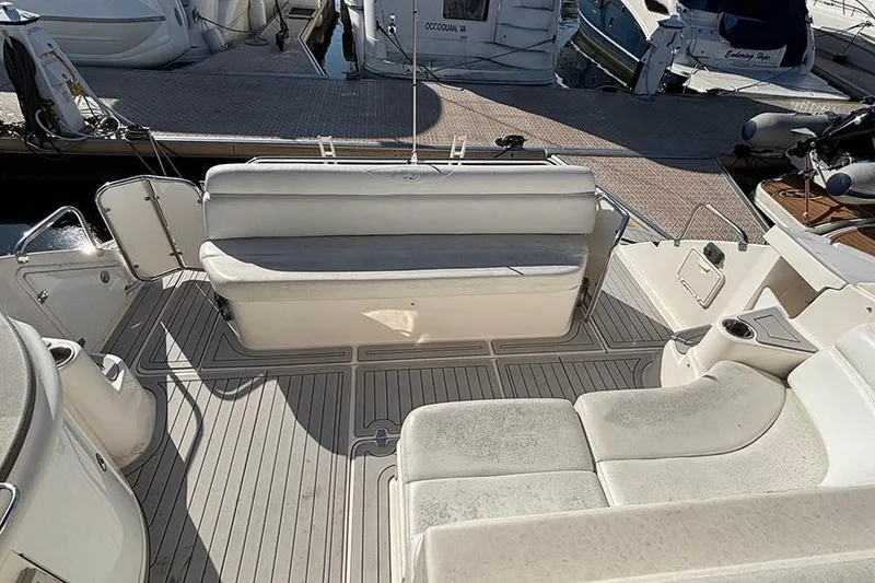 Slide: The Image of 2005 Regal Commodore 4260 yacht interior with white seating and deck view. - 14