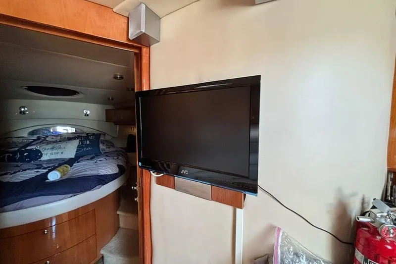 Slide: The Image of Interior of 2005 Regal Commodore 4260 yacht with TV and cozy bedroom. - 19