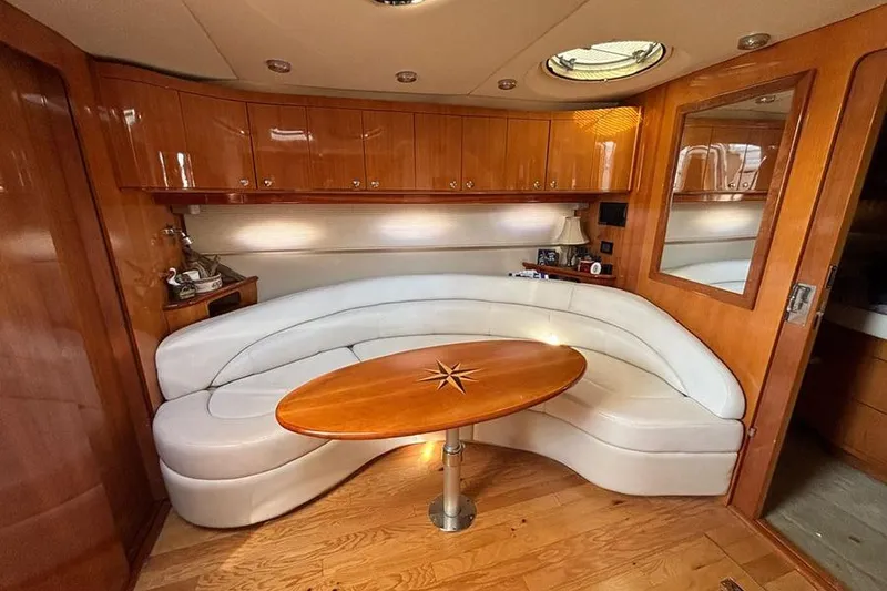 Slide: The Image of Luxurious 2005 Regal Commodore 4260 yacht interior with curved seating and elegant wood finishes. - 20