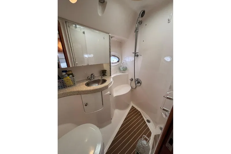 Slide: The Image of 2005 Regal Commodore 4260 yacht bathroom with shower, sink, and mirror. - 21