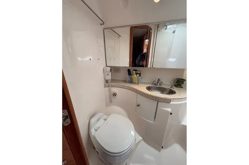 Slide: The Image of Bathroom interior of 2005 Regal Commodore 4260 yacht, featuring sink and toilet. - 23